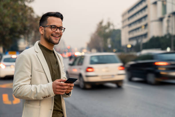 istock Modern Professional Using Smartphone While Hailing Taxi On City Street Evening 2193977954
