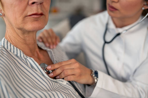 istock Caring Female Doctor Using Stethoscope During Senior Patient Home Visit 2193978013