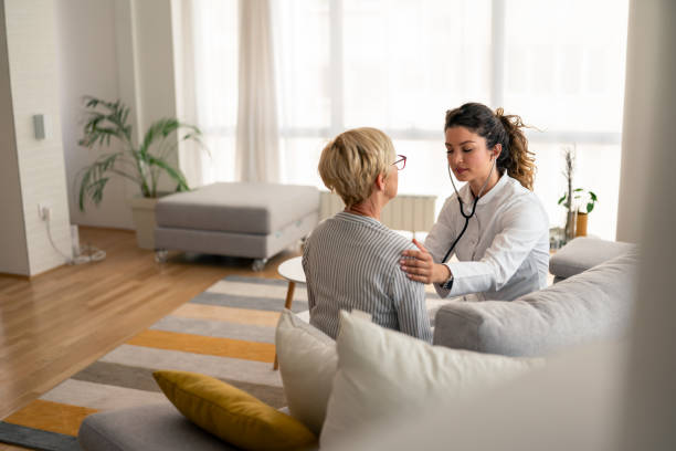 istock Caring Female Doctor Using Stethoscope During Senior Patient Home Visit 2193978065
