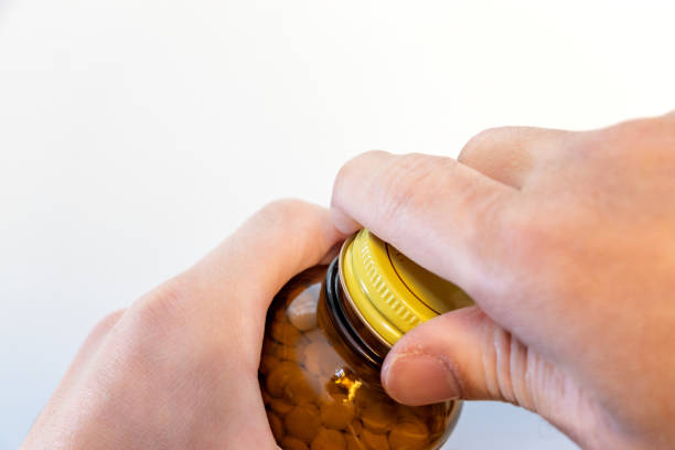 istock Turn the cap on a bottle of pills 2193978095