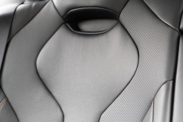istock Back passenger black seats in modern luxury car. Black perforated leather with white stitching. Car details. Leather comfortable seats. Car interior details 2193978851