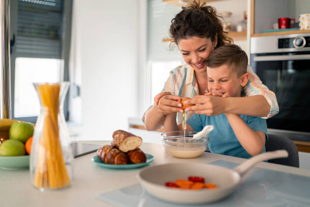 istock Caucasian Mother and Young Boy Learning Kitchen Skills During Meal Preparation 2193979219