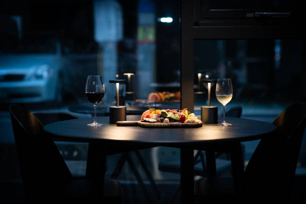istock Wine cups and food on the table under the dark cafe lighting 2193981525