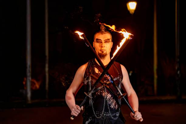istock Fire performer holding flaming swords at night 2193982601