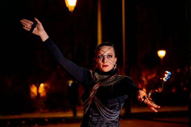 istock Fire dancer performing with flaming props in night cityscape 2193982934