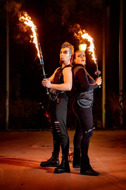 istock Fire dancers performing with torches at night, creating a spectacular show 2193982935