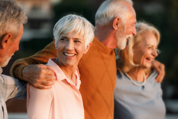 istock Cheerful senior friends walking embraced in nature. 2193982955