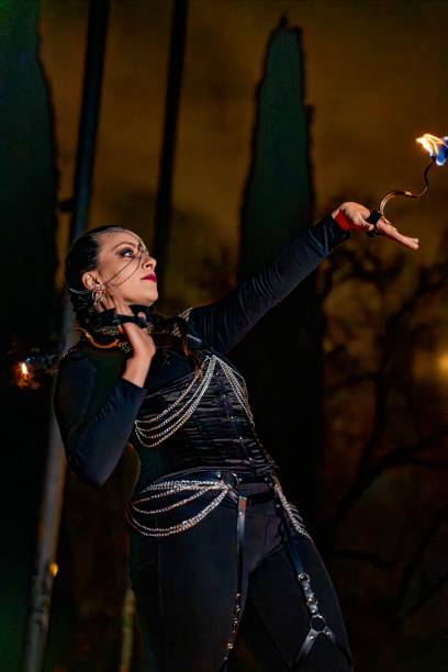 istock Fire performer dancing with flaming props at night 2193983374