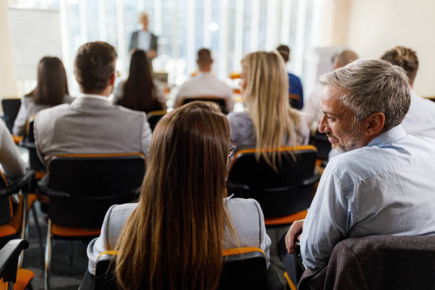 istock Business colleagues talking on education event in board room. 2193983892