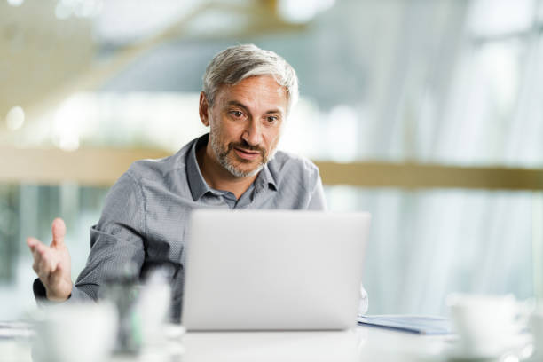 istock Businessman talking during conference call over laptop in the office. 2193984043