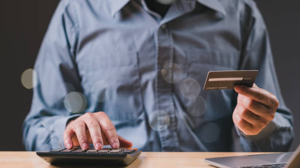 istock A man is holding a credit card and using a calculator 2193985059