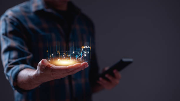 istock A man is holding a cell phone and has a graph for economy in 2025 2193985174