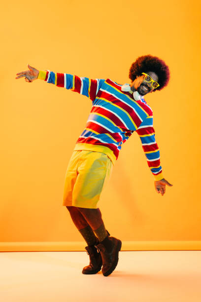 Sport and fashion. High-fashion style man playing basketball with glitch duotone effect. Young sporty model at studio and double colorful shadows. Contemporary artwork. Concept of art, ad, sales