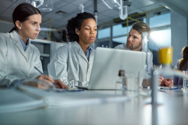 istock Students of science working on laptop in laboratory. 2193986383