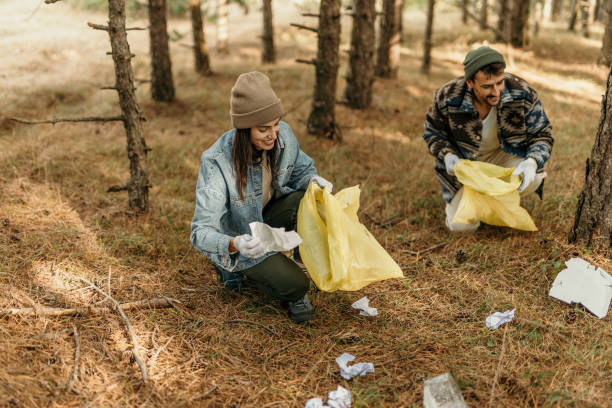 Couple clean a park trail