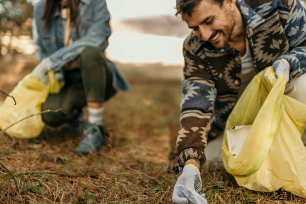 istock Couple clean a park trail 2193989205