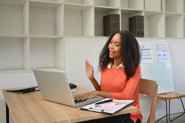 istock Smiling African office worker having video call on her laptop 2193989601