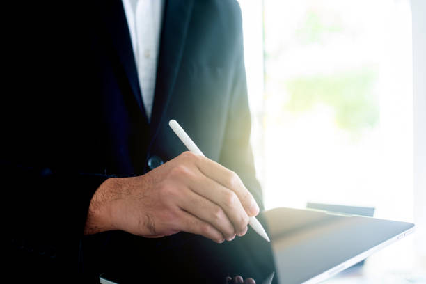 istock Young businness man in front, businessman using pen, Financial analysis or business evaluation concept 2193990421