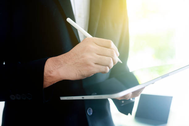 istock Young businness man in front, businessman using pen, Financial analysis or business evaluation concept 2193990431