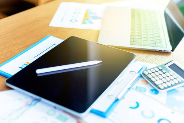 Work space at home, Businessman or an accountant are analyzing data charts, graphs, and discuss financial data in an office, Financial analysis or business evaluation concept