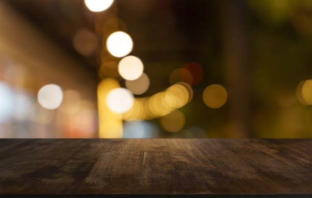 istock Empty wood table top and blur of restaurant background selective focus product display 2193990557