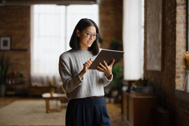 istock Happy Chinese businesswoman using digital tablet in a modern office. 2193991186