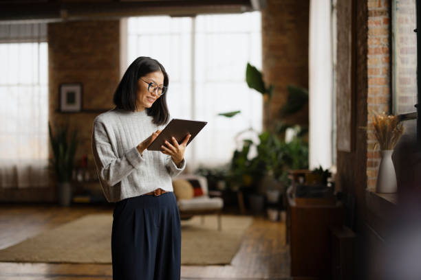 istock Happy Asian woman using touchpad at home. 2193991188