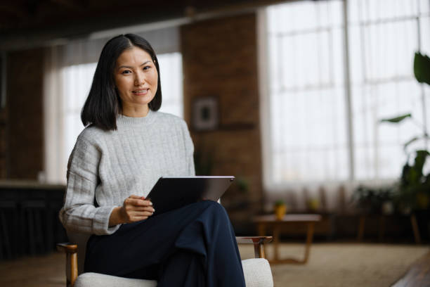 istock Happy Asian woman using touchpad at home. 2193991273