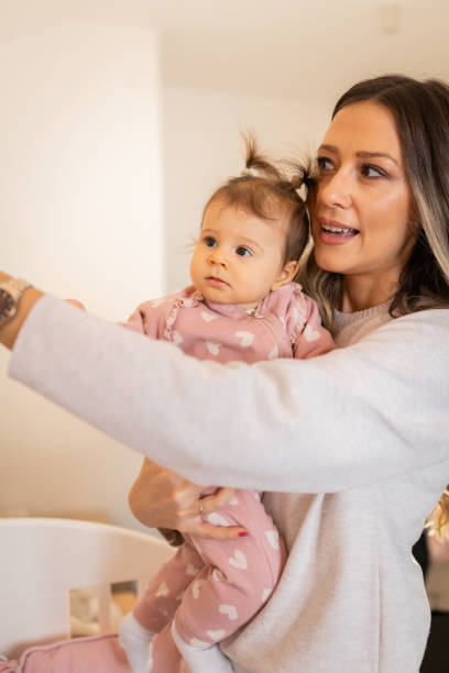istock Mother holding baby daughter at home 2193991292