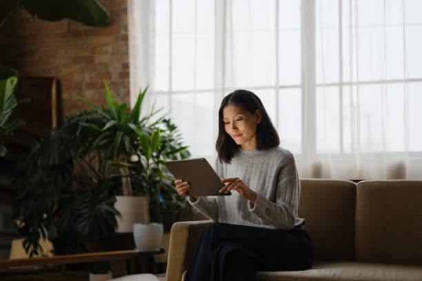 istock Smiling Asian businesswoman using touchpad in casual office. 2193991844