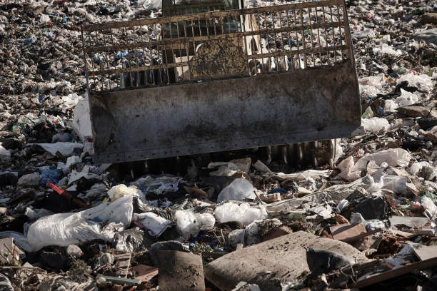 istock Heavy machinery shredding garbage in an open air landfill. Pollution 2193991850