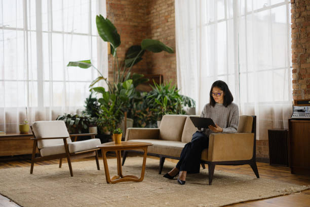Asian businesswoman working on touchpad in a modern office.