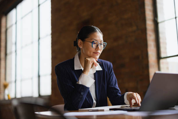 istock Chinese female entrepreneur working on laptop in a modern office. 2193991969