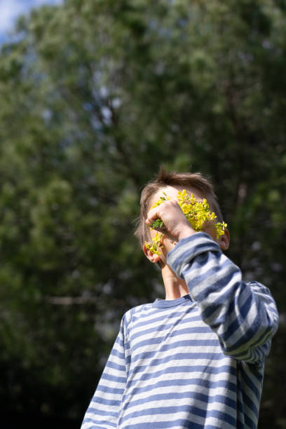 little happy boy and colorful flower garden