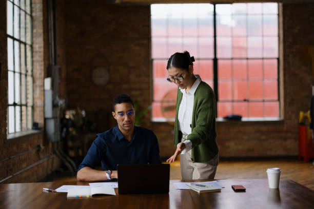 istock Diverse business colleagues working on laptop in the office. 2193992440