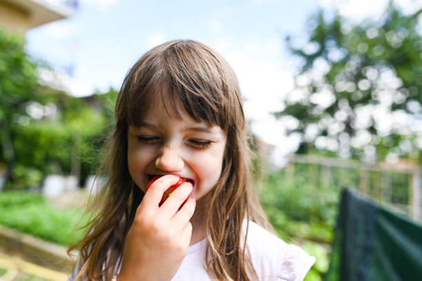 Cute girl eating strawberry.