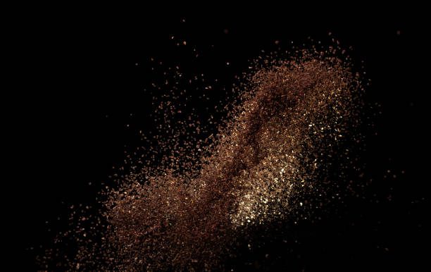 istock Roasted Coffee powder ground dust splash explosion in mid Air. Ground Coffee roasted powder dust fly explosion, Coffee crushed ground float pouring. Black background Isolated 2193992629