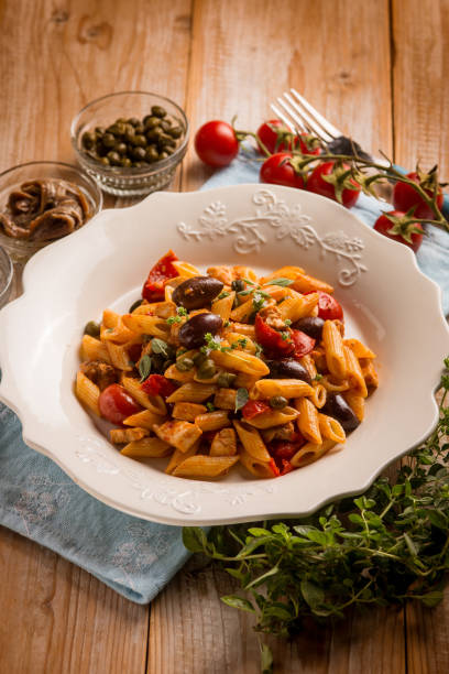 istock pasta with sword fish tomato black olives and capers 2193993377