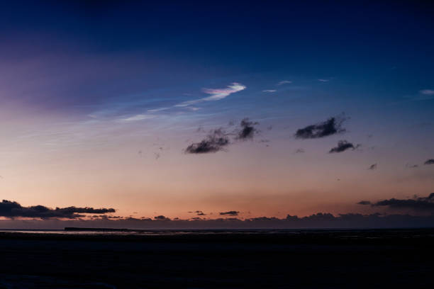 Polar stratospheric clouds glowing at twilight over South Iceland's horizon