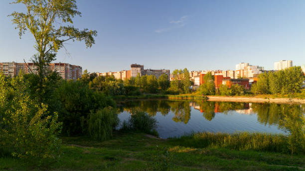 istock Park with a pond and trees in the background 2193996905