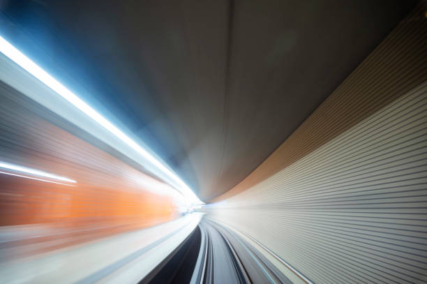 Long exposure of the view from the train of a self-driving subway in Nuremberg while passing a station in the tunnel.