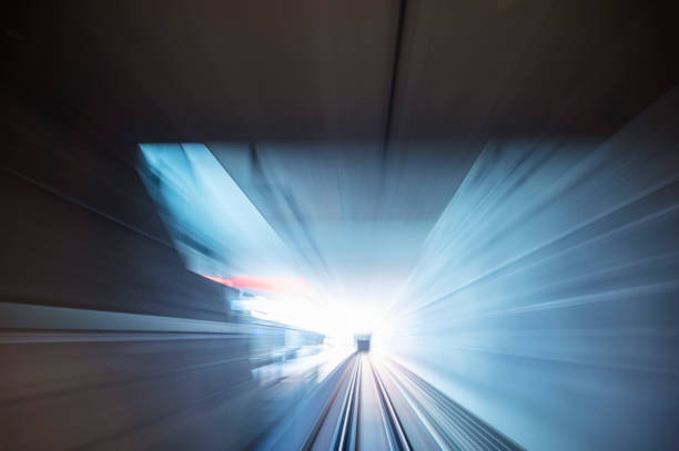 Long exposure of the view from the train of a self-driving subway in Nuremberg while passing a station in the tunnel.