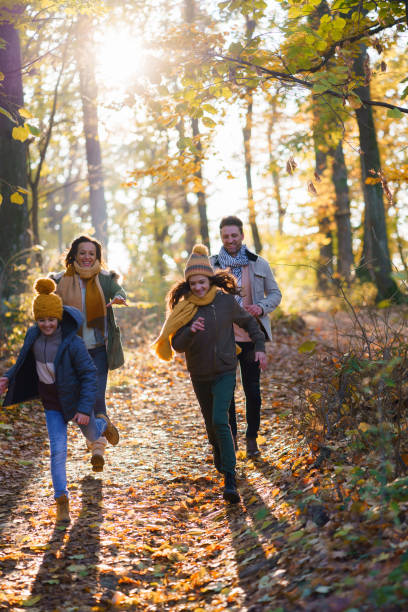 istock Family having fun running in the forest 2193998323