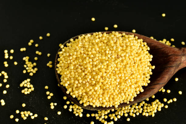 istock In a wooden spoon there is cereal, millet. 2193998408