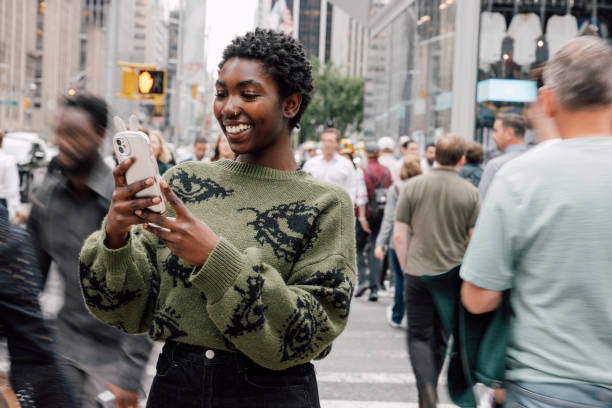 istock Young woman texting in the street 2193999312