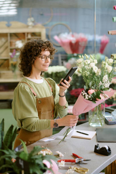 istock Florist Showing Bouquet on Social Network 2193999381