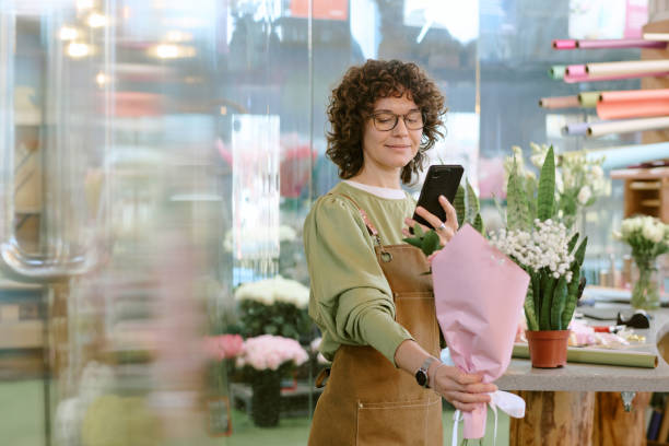 istock Smiling Florist Advertising New Bouquet 2193999423