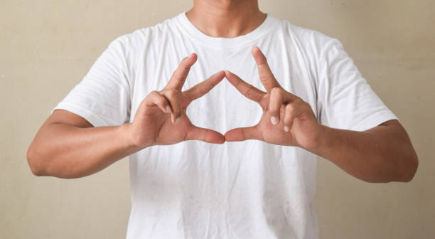 istock young man showing sign language with hand gestures speaking body language, hearing impaired interpreter 2194001480
