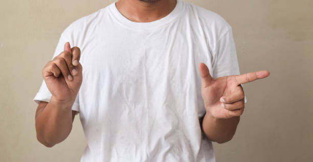 istock young man showing sign language with hand gestures speaking body language, hearing impaired interpreter 2194001486