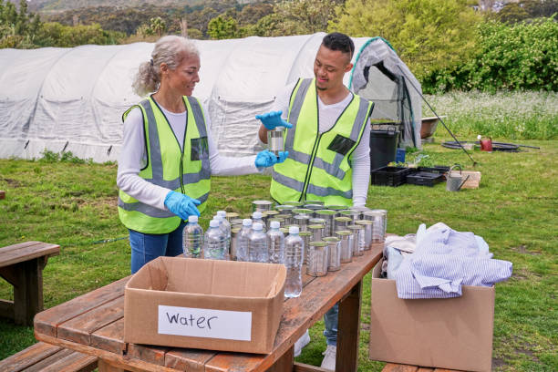 istock Two volunteers packaging donation boxes at table outdoors 2194003110